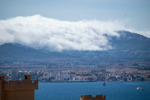 Clouds coming over mountains